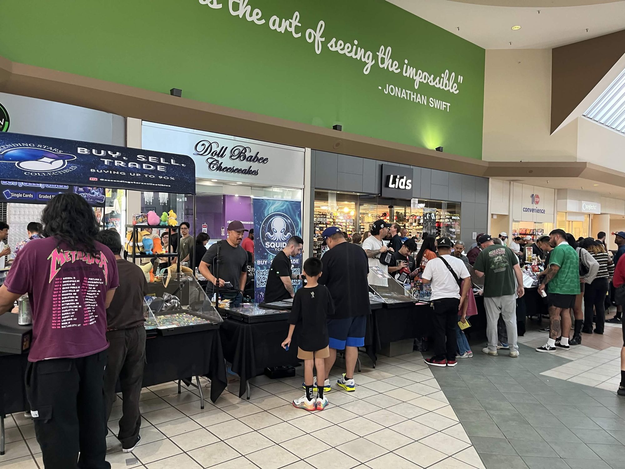 Collectors shopping a row of vendor tables at Lakewood Center Mall