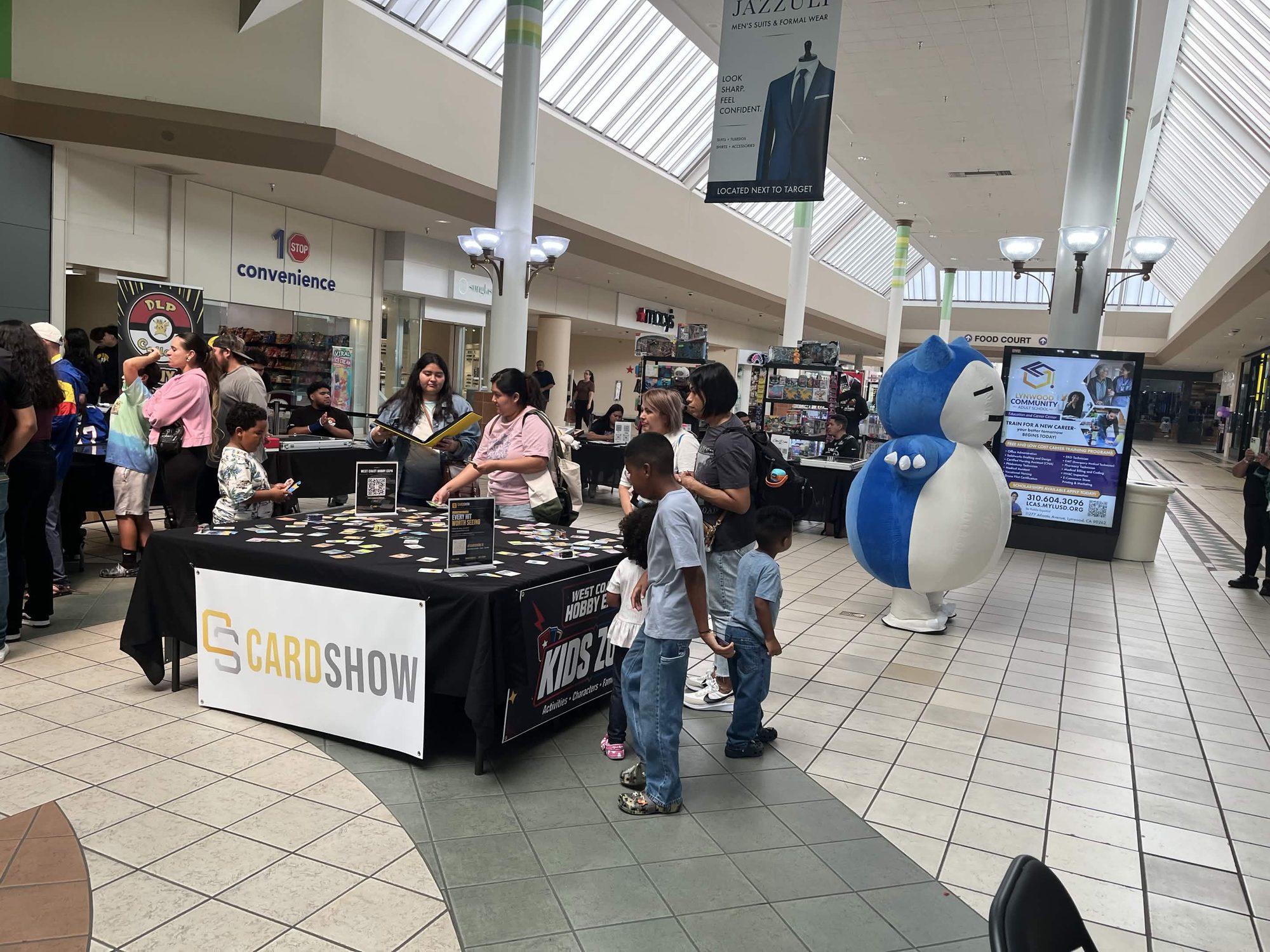 Families at the Kids Zone table with a Snorlax mascot