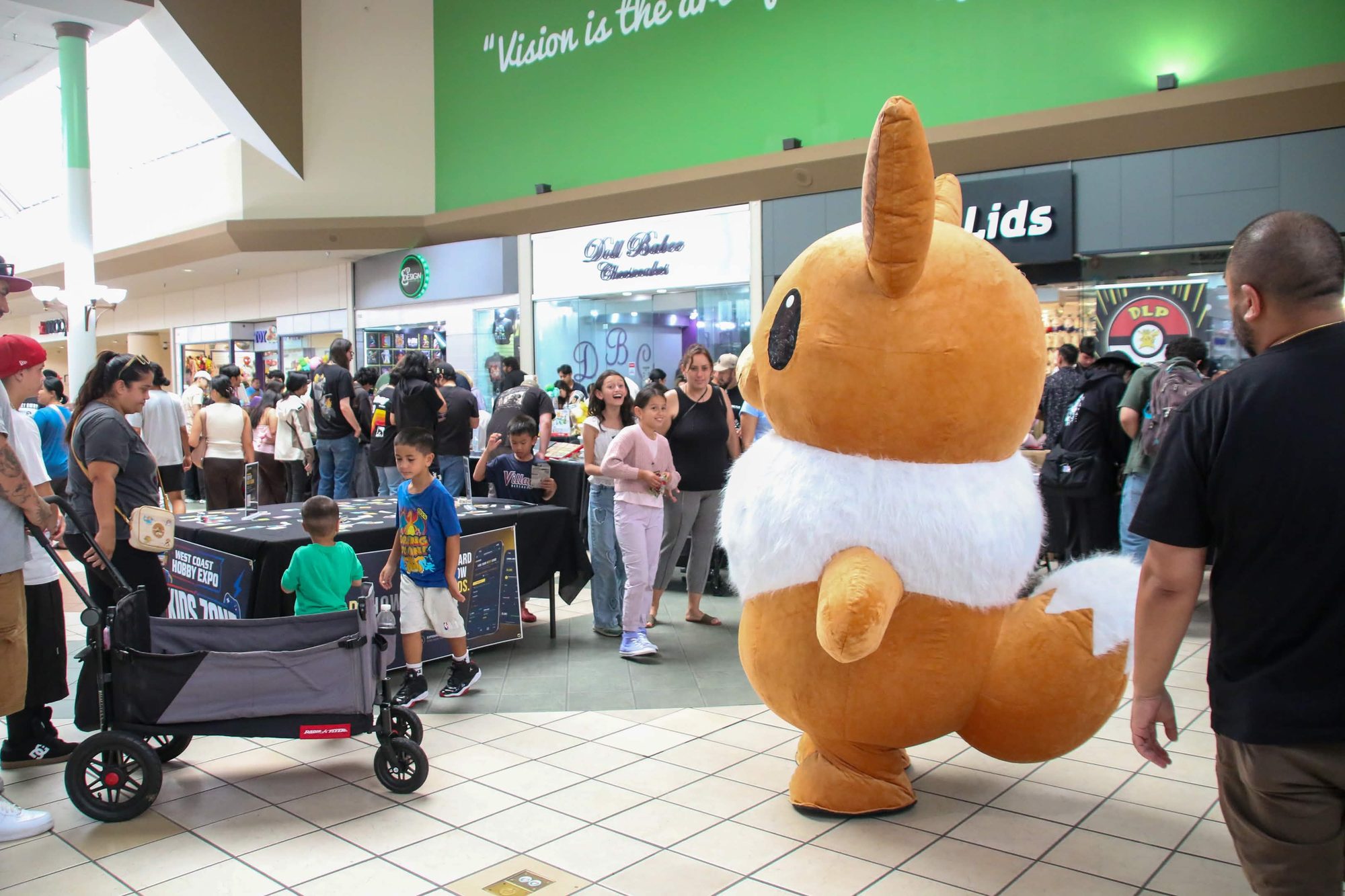 Eevee mascot greeting kids at the Kids Zone